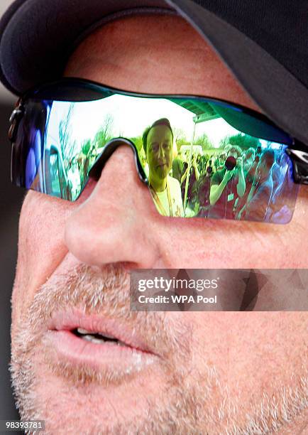 Conservative leader David Cameron, Britain's opposition party, is reflected in the sunglasses of former cricketer Ian Botham, after they took part in...