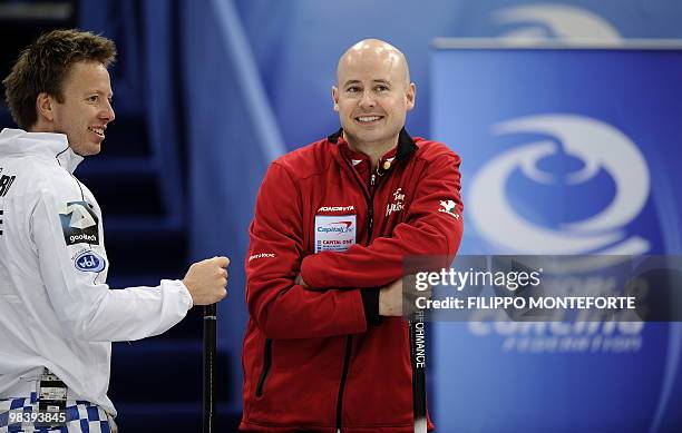Canada's skipper Kevin Koe and Norway's skipper Torger Nergard smile during the Men's world curling championship final in Cortina D'Ampezzo on April...