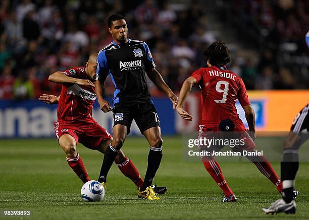 Ryan Johnson of the San Jose Earthquakes controls the ball between C.J. Brown and Baggio Husidic of the Chicago Fire in an MLS match on April 10,...