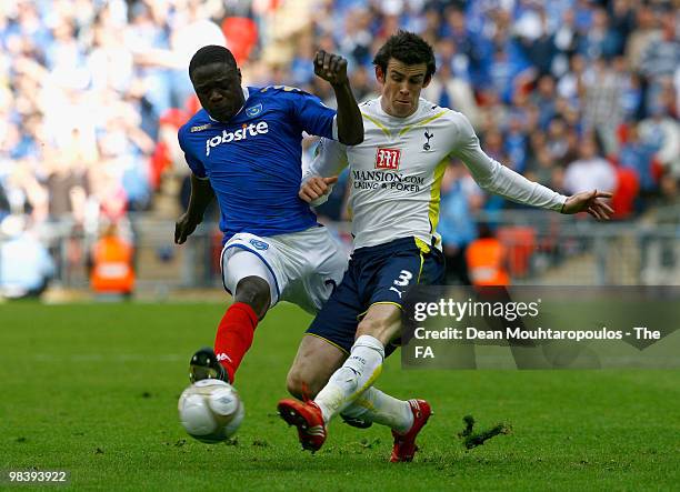 Gareth Bale of Tottenham Hotspur is tackled by Aruna Dindane of Portsmouth during the FA Cup sponsored by E.ON Semi Final match between Tottenham...