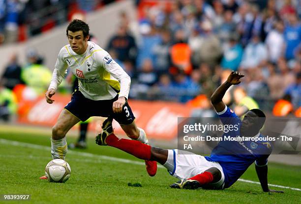 Gareth Bale of Tottenham Hotspur evades the tackle by Aruna Dindane of Portsmouth during the FA Cup sponsored by E.ON Semi Final match between...