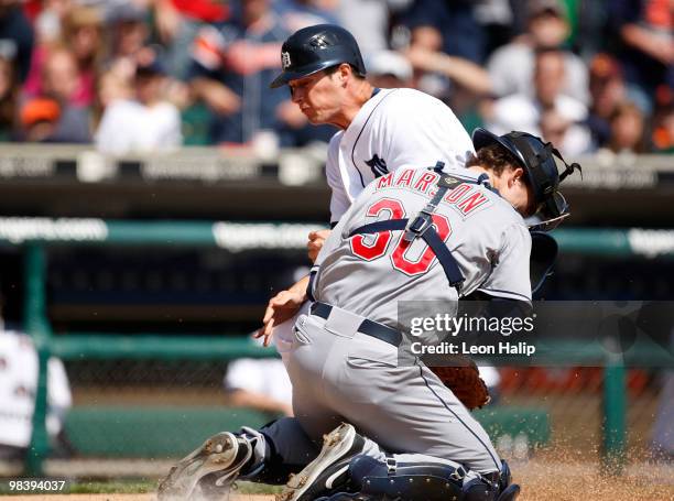 Lou Marson of the Cleveland Indians tags out Don Kelly of the Detroit Tigers at home plate in the third inning on April 11, 2010 at Comerica Park in...