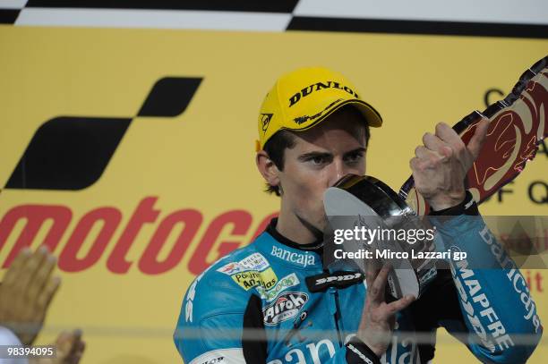 Nico Terol of Spain and Bancaja Aspar Team celebrates on the podium the victory at the end of the 125 cc race of the Qatar Grand Prix at Losail...