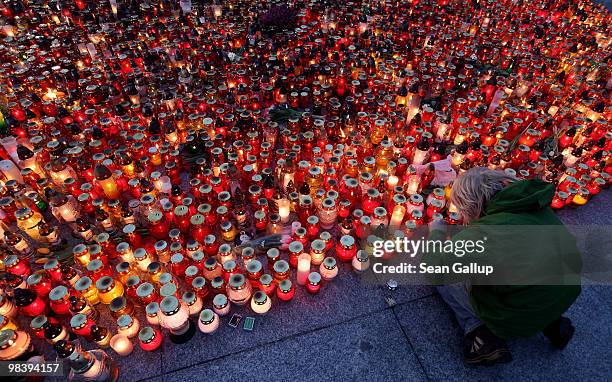 Little boy tries to light a candle to add it to thousands of others left by mourners at Pilsudski Square in memory of late Polish President Lech...