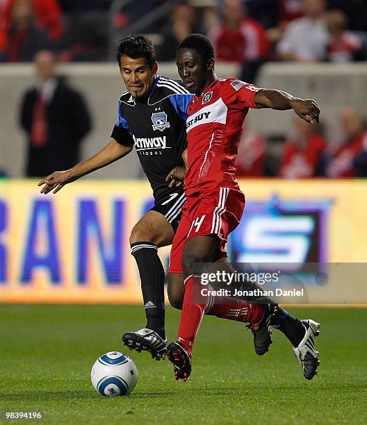 Patrick Nyarko of the Chicago Fire moves with the ball under pressure from Ramon Sanchez of the San Jose Earthquakes in an MLS match on April 10,...