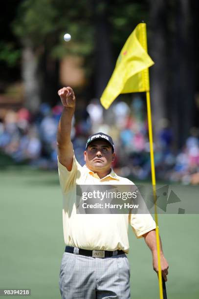 Angel Cabrera of Argentina tosses his golf ball to his caddie on the second hole during the final round of the 2010 Masters Tournament at Augusta...