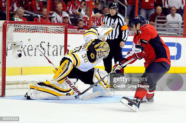 Tim Thomas of the Boston Bruins makes a save during the shoot out against Matt Bradley of the Washington Capitals at the Verizon Center on April 11,...