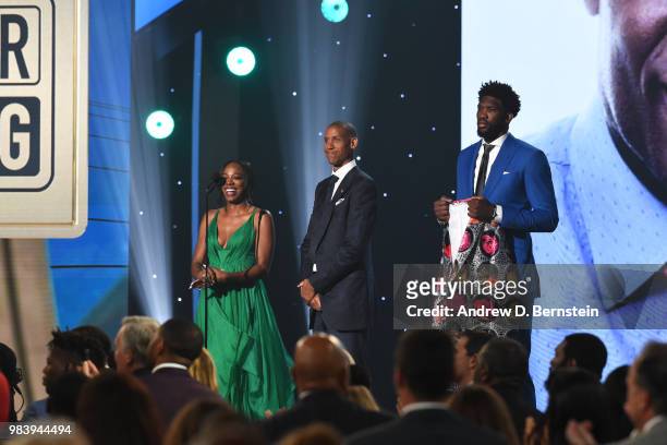 Reggie Miller, Yvonne Orji and Joel Embiid of the Philadelphia 76ers present Dikembe Mutombo with the Craig Sager Strong Award during the 2018 NBA...