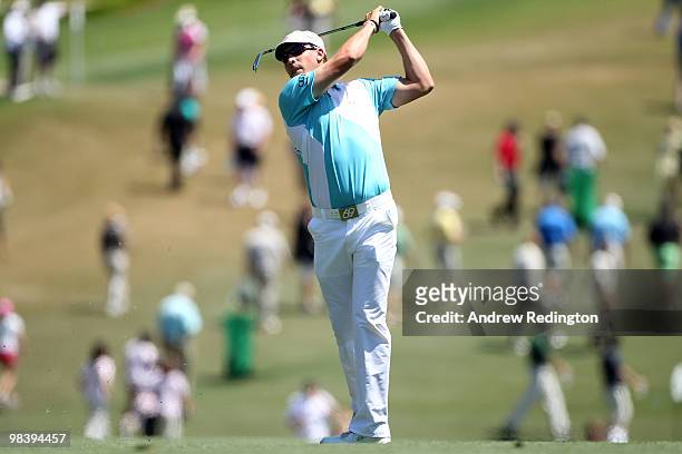 Ricky Barnes watches his approach shot on the first hole during the final round of the 2010 Masters Tournament at Augusta National Golf Club on April...