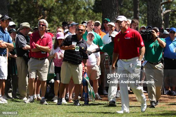 Lee Westwood of England walks to the fairway on the first hole after playing a shot in front of a gallery of fans during the final round of the 2010...