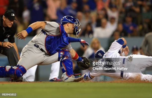 Chris Gimenez of the Chicago Cubs tags out Justin Turner of the Los Angeles Dodgers during the sixth inning of a game at Dodger Stadium on June 25,...