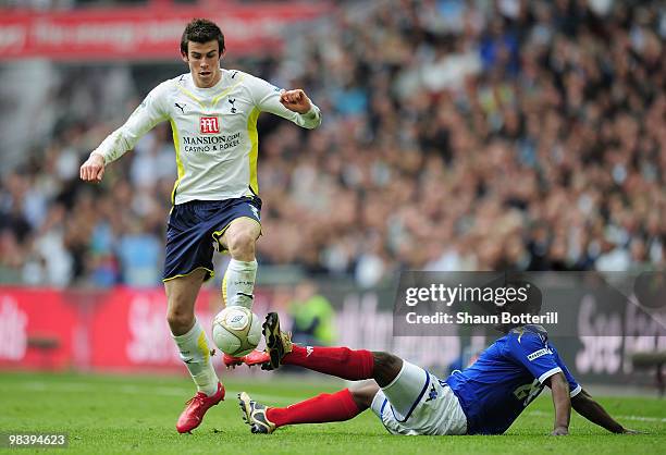 Gareth Bale of Tottenham Hotspur evades the tackle by Aruna Dindane of Portsmouth during the FA Cup sponsored by E.ON Semi Final match between...