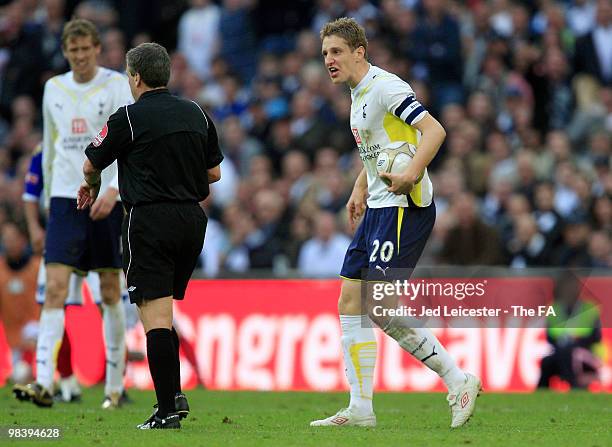 Michael Dawson of Tottenham Hotspur exchanges words with referee Alan Wiley during the FA Cup sponsored by E.ON Semi Final match between Tottenham...