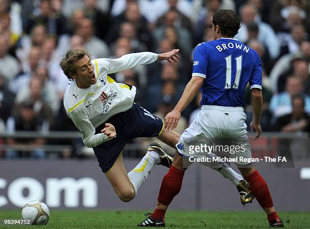 Peter Crouch of Tottenham Hotspur falls as he is tackled by Michael Brown of Portsmouth during the FA Cup sponsored by E.ON Semi Final match between...