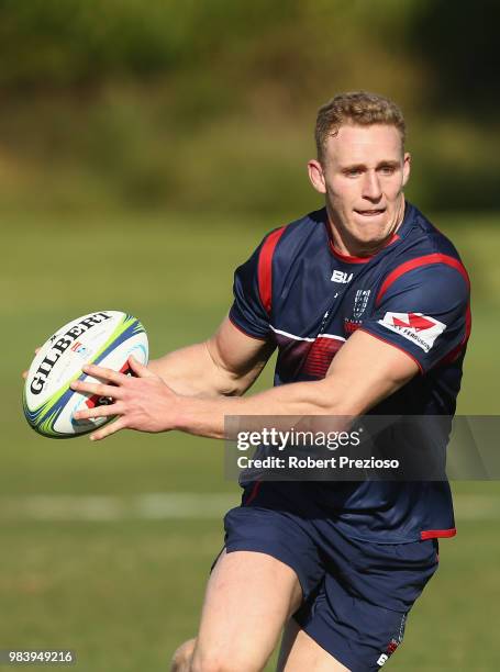 Reece Hodge looks to offload the ball during a Melbourne Rebels Super Rugby training session at AAMI Park on June 26, 2018 in Melbourne, Australia.