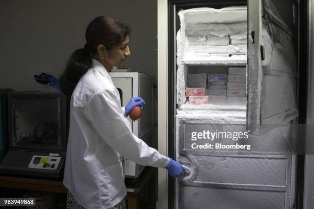 Technician opens a freezer storing different types of bacteria at a GangaGen Inc. Laboratory in Bengaluru, India, on Wednesday, May 30, 2018. The...