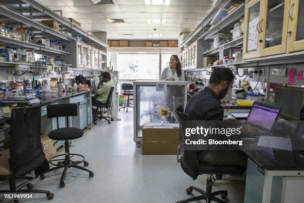 Employees work inside a Biomoneta laboratory in Bengaluru, India, on Friday, June 1, 2018. The rapid spread of resistant bacteria has made India the...