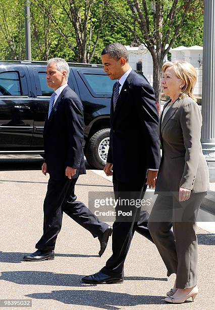 President Barack Obama , flanked by White House Chief of Staff Rahm Emanuel and Secretary of State Hillary Clinton , walks from the White House to...