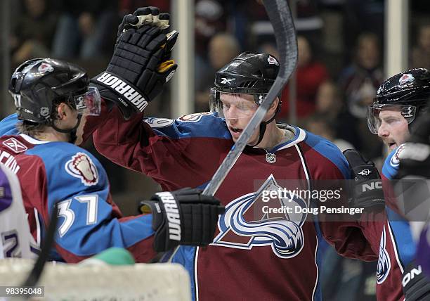 Ryan Stoa of the Colorado Avalanche celebrates his first period goal with Ryan O'Reilly and Milan Hejduk against the Los Angeles Kings play during...