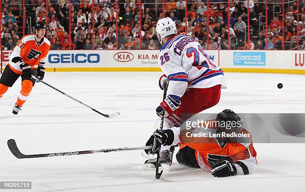Darroll Powe of the Philadelphia Flyers is upended off the puck by Erik Christensen of the New York Rangers on April 11, 2010 at the Wachovia Center...