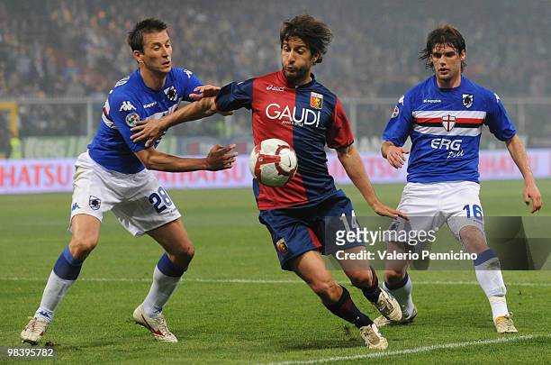 Giuseppe Sculli of Genoa CFC is challenged by Daniele Gastaldello and Andrea Poli of UC Sampdoria during the Serie A match between UC Sampdoria and...