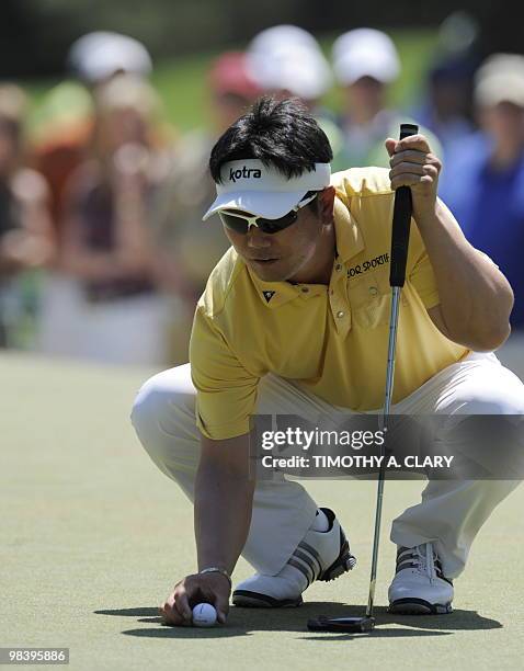 Yong-Eun Yang of Korea lines a putt on the 1st hole during the final round of the Masters Golf Tournament at Augusta National Golf Club on April 11,...