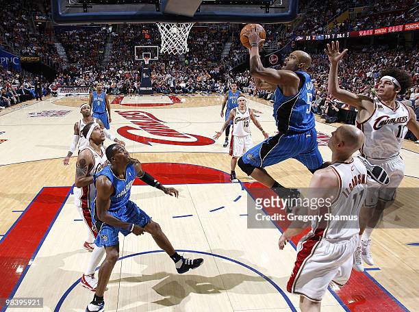 Vince Carter of the Orlando Magic gets to the basket between Anderson Varejao and Zydrunas Ilgauskas of the Cleveland Cavaliers on April 11, 2010 at...