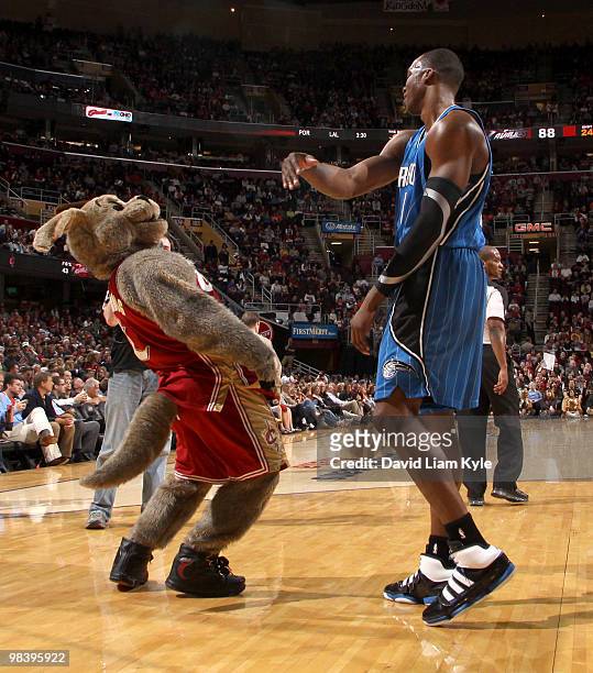 Dwight Howard of the Orlando Magic playfully swats at Cleveland Cavaliers mascot Moondog during a break in the action on April 11, 2010 at The...