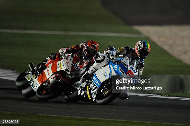 Stefan Bradl of Germany and Viessmann Kiefer Racing crashed out with Alex De Angelis of San Marino and Scot Racing Team during the Moto2 race of the...