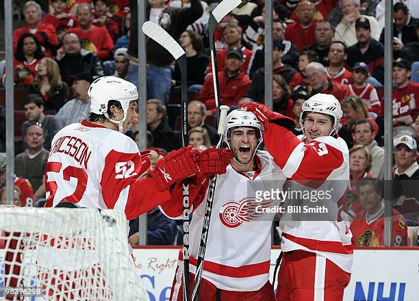 Patrick Eaves of the Detroit Red Wings celebrates with teammates Jonathan Ericsson and Darren Helm after scoring against the Chicago Blackhawks on...