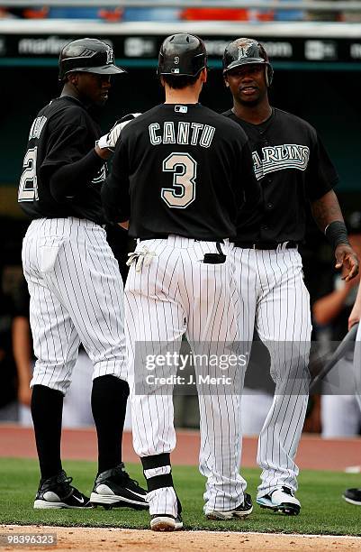 Third baseman Jorge Cantu of the Florida Marlins is congratulated by teammates Cameron Maybin and Hanley Ramirez after hitting a three-run home run...