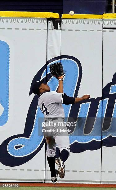 Outfielder Curtis Granderson of the New York Yankees catches a fly ball against the Tampa Bay Rays during the game at Tropicana Field on April 11,...
