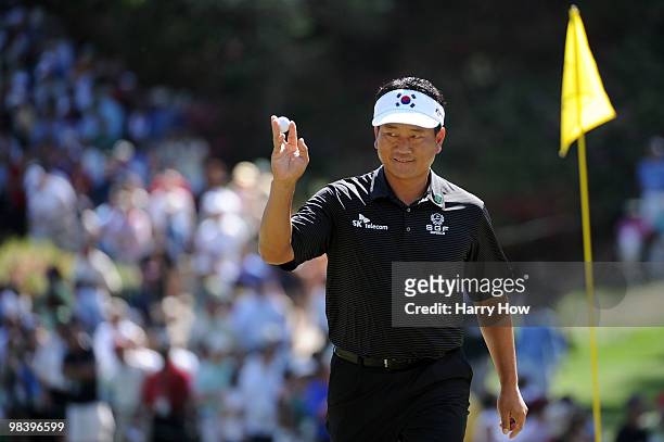 Choi of South Korea waves to the gallery on the eighth green during the final round of the 2010 Masters Tournament at Augusta National Golf Club on...