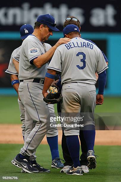Manager Joe Torre of the Los Angeles Dodgers checks on third baseman Ronnie Belliard after throwing to first to force out Cody Ross of the Florida...