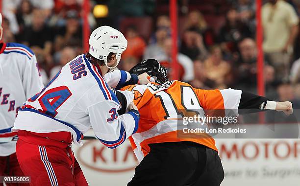 Ian Laperriere of the Philadelphia Flyers tangles with Aaron Voros of the New York Rangers on April 11, 2010 at the Wachovia Center in Philadelphia,...