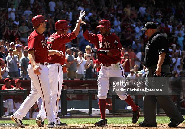 Chris Young of the Arizona Diamondbacks is congratulated by teammates Adam LaRoche and Mark Reynolds after Young hit a 3 run home run against the...