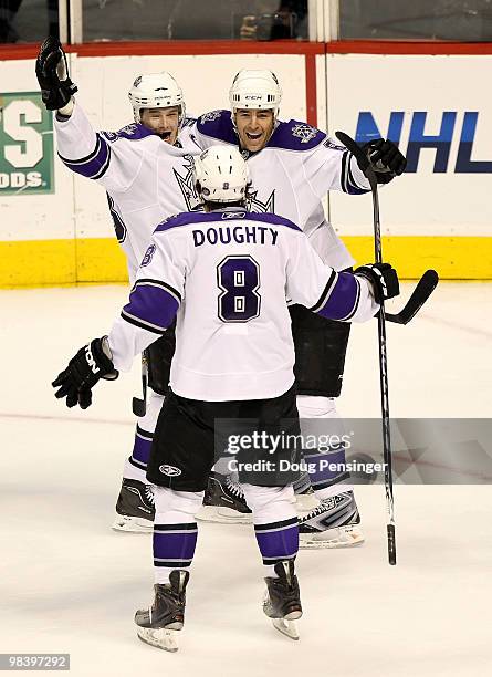 Dustin Brown of the Los Angeles Kings celebrates his game winning overtime goal with teammate Sean O'Donnell and Drew Doughty against the Colorado...