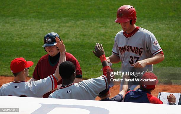 Stephen Strasburg of the Harrisburg Senators is congratulated by teammates after scoring a run against the Altoona Curve in his minor league debut...