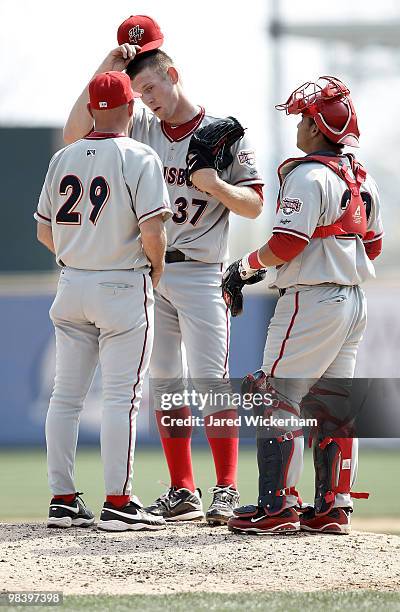 Stephen Strasburg talks with pitching coach Randy Tomlin and Jhonatan Solano of the Harrisburg Senators during the game against the Altoona Curve on...