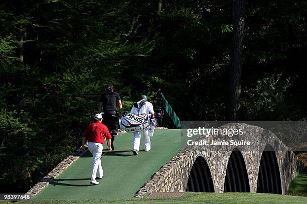Lee Westwood of England , Phil Mickelson and caddie Billy Foster walk to the Hogan Bridge during the final round of the 2010 Masters Tournament at...