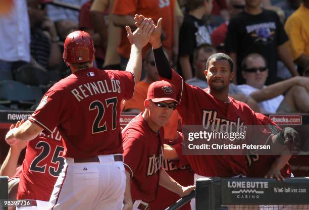 Manager A.J. Hinch and Chris Young of the Arizona Diamondbacks congratulate teammate Mark Reynolds after scoring against the Pittsburgh Pirates...