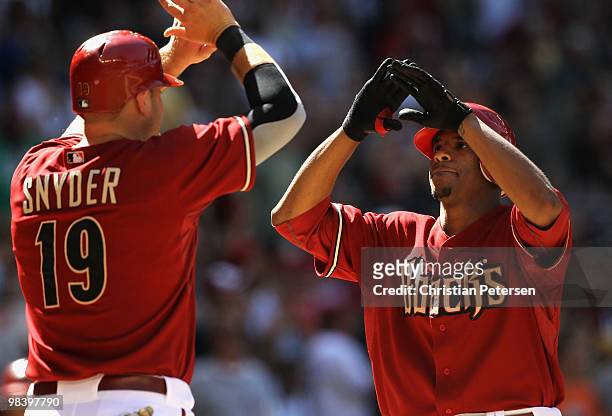 Edwin Jackson of the Arizona Diamondbacks is congratulated by teammate Chris Snyder after Jackson hit a 2 run home run against the Pittsburgh Pirates...