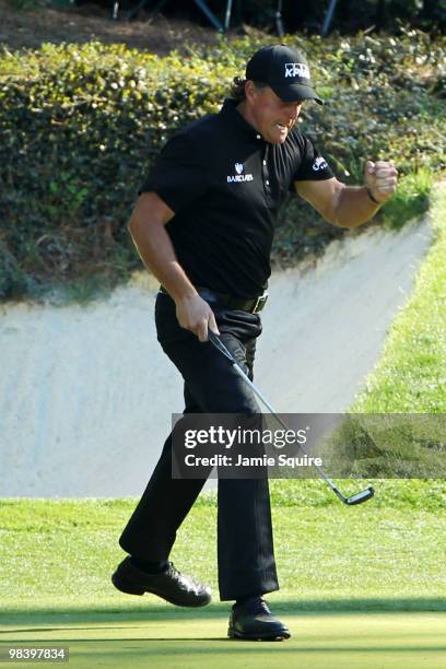 Phil Mickelson reacts to a birdie putt on the 12th green during the final round of the 2010 Masters Tournament at Augusta National Golf Club on April...