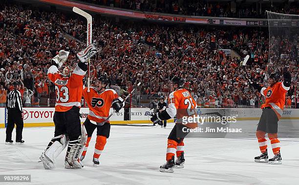 Brian Boucher of the Philadelphia Flyers celebrates his game winning shootout save against the New York Rangers with teammates Daniel Briere, Matt...
