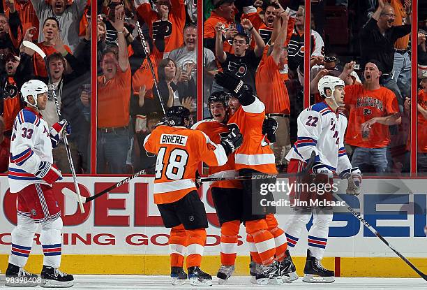 Matt Carle of the Philadelphia Flyers celebrates his third period game tying goal with teammates Daniel Briere and Scott Hartnell as Michal Rozsival...