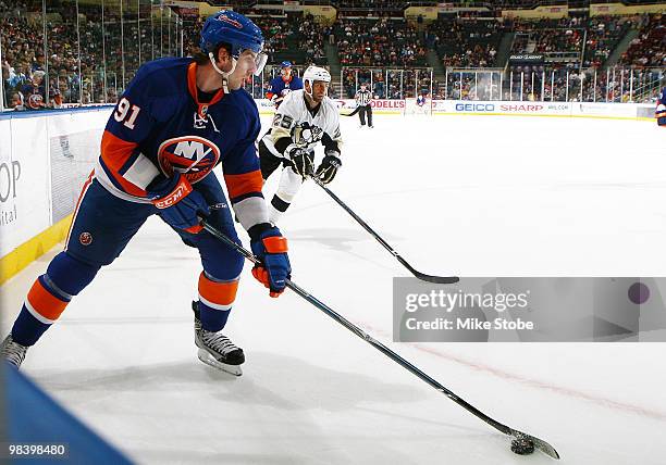 John Tavares of the New York Islanders controls the puck in front of Maxime Talbot of the Pittsburgh Penguins on April 11, 2010 at Nassau Coliseum in...