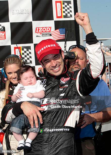 Helio Castroneves of Brazil, driver of the Team Penske Dallara Honda celebrates in victory lane with his daughter Mikaella after winning the Indy...