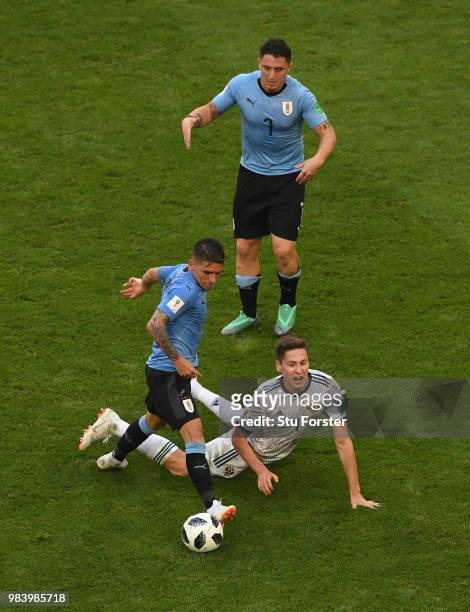 Uruguay players Lucas Torreira and Cristian Rodriguez combine to thwart Russia player Daier Kuziaev during the 2018 FIFA World Cup Russia group A...