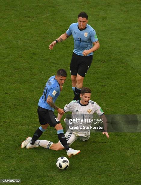 Uruguay players Lucas Torreira and Cristian Rodriguez combine to thwart Russia player Daier Kuziaev during the 2018 FIFA World Cup Russia group A...