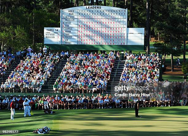Phil Mickelson watches a putt on the 15th green as Lee Westwood of England looks on during the final round of the 2010 Masters Tournament at Augusta...